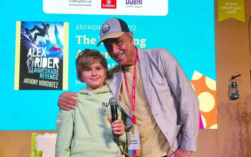 A photo of Anthony Horowitz and a young attendee of his Emirates LitFest children's session